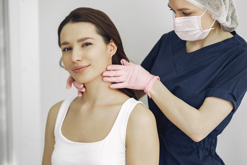 Médica examinando a pele de uma paciente durante uma consulta
